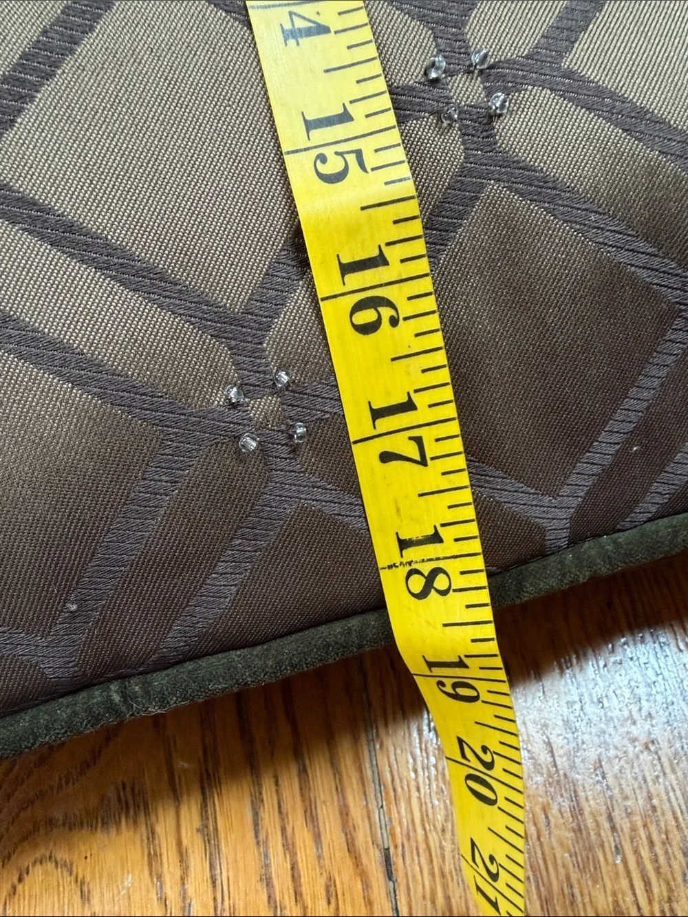 Reba green velour pillow with embroidered scroll design on front.